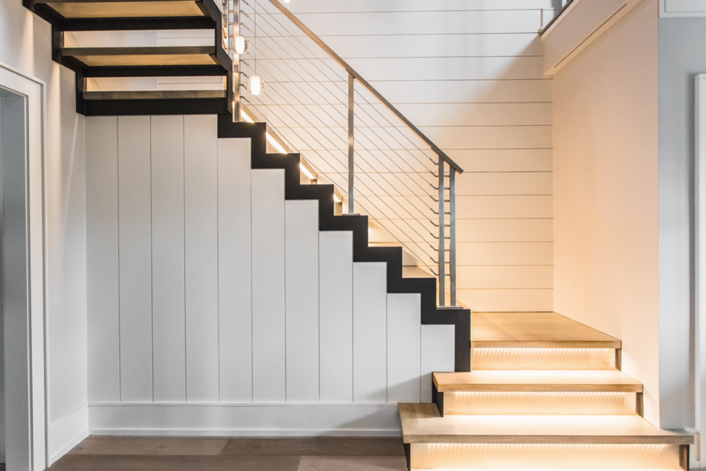 A combination of steel stringers with stainless steel railing posts, kick plates and stainless cable railings.