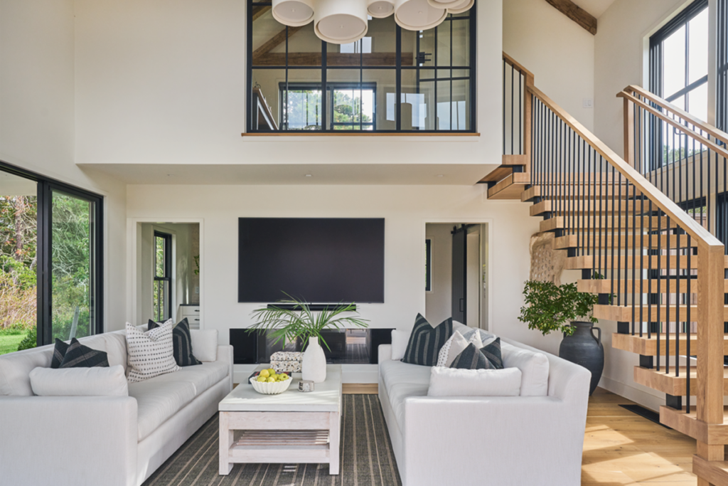 Double stringer floating stairs with spindle railings and white oak treads and handrails.