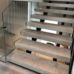 Glass railing with double stringer stringers cables and oak treads Keuka Studios