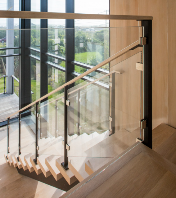 Glass Railing on open floating staircase with black railing posts.